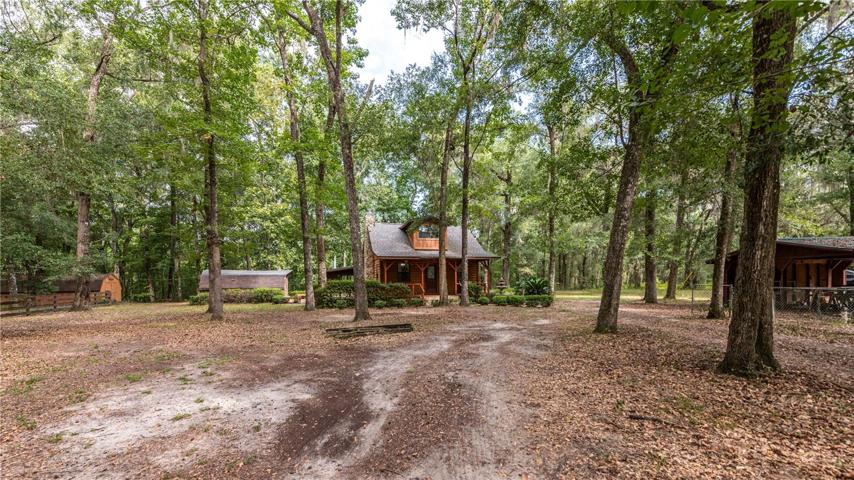Front of home with the storage sheds and pole barn