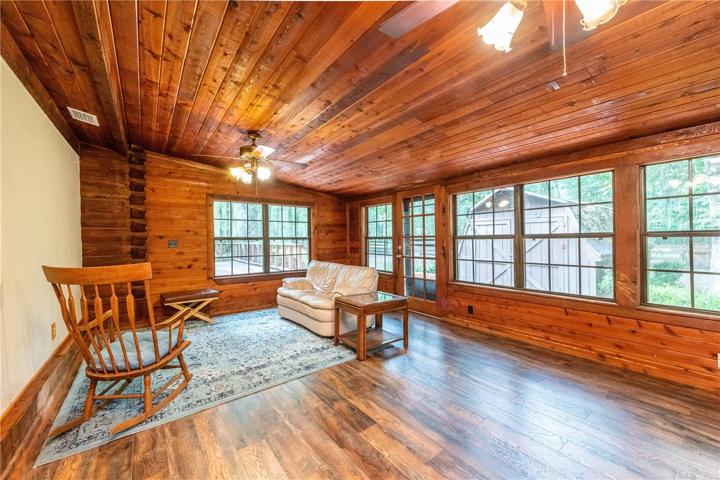 Living room with 2 ceiling fans and a wood burning fireplace.