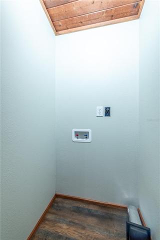 Inside washer and dryer hookups behind a barn door