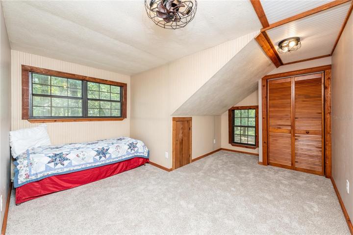 Bedroom 2 with mini fan and new carpet is upstairs