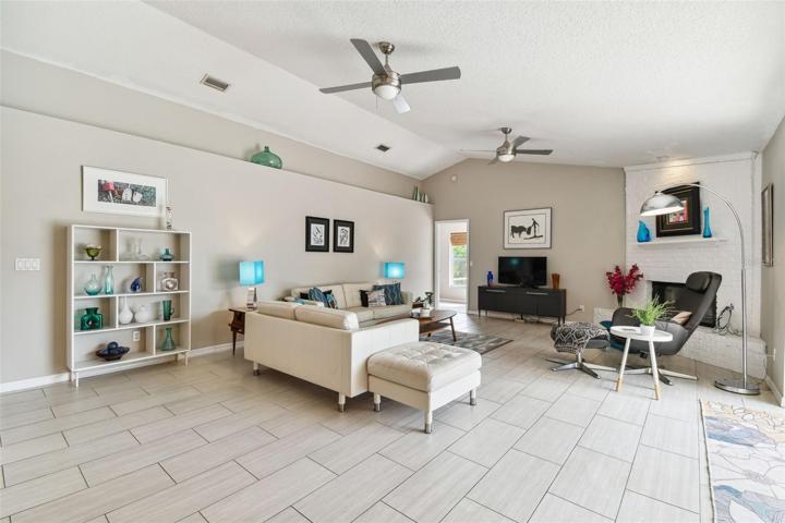 Great Room with woodburning fireplace and entry to 4th bedroom