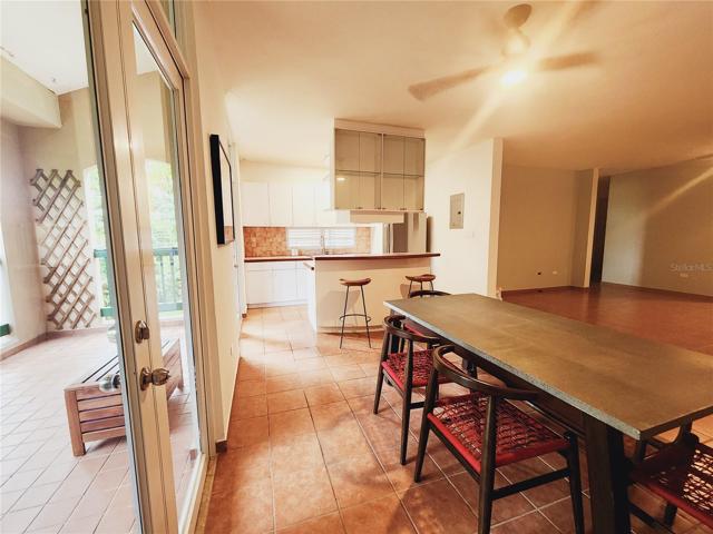 View of kitchen, dinner area and balcony.