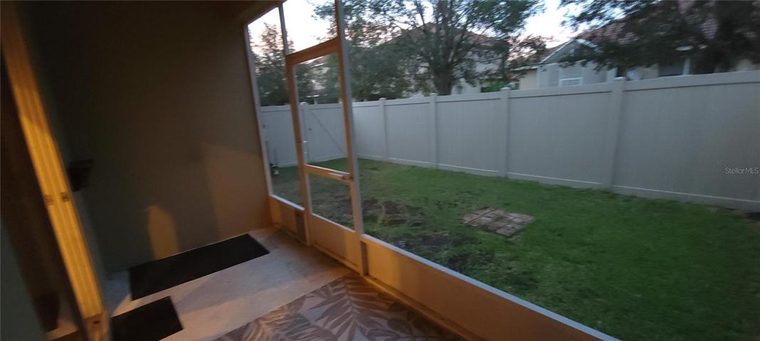 Patio and fenced backyard