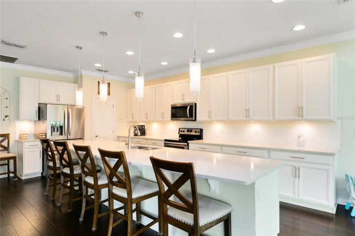A stunning quartz breakfast bar and countertops create an inviting focal point.