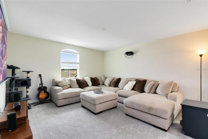 Venture upstairs to a spacious loft area, the ideal spot for hosting movie nights or cheering for your favorite team.