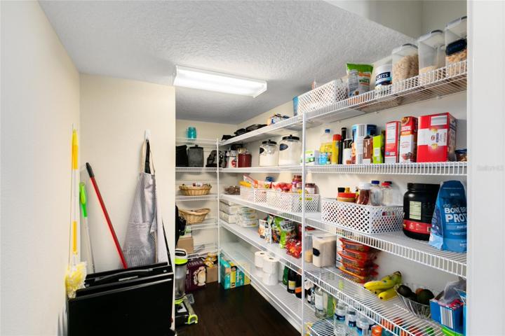 The generous walk-in pantry provides ample storage space, ensuring an organized and clutter-free kitchen.