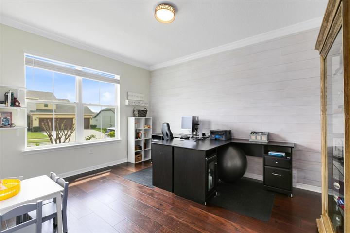 To your left, a pair of elegant French doors unveil a versatile home office, perfect for productive days.