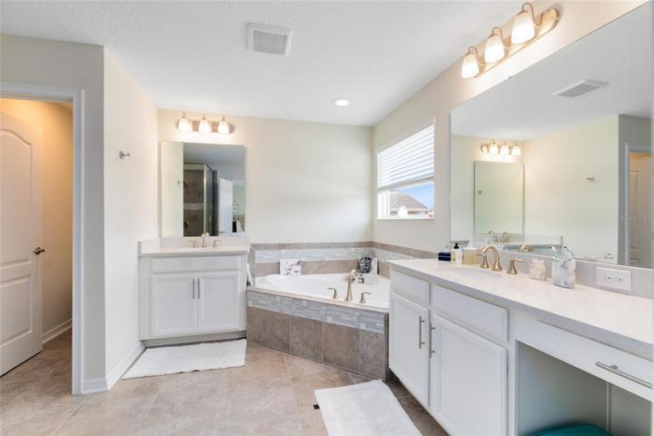 The master en suite bath is a testament to luxury, featuring dual vanities along with a sumptuous garden.  tub