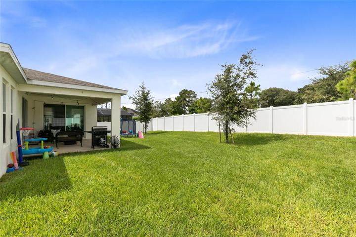 A spacious fenced backyard holds endless possibilities.