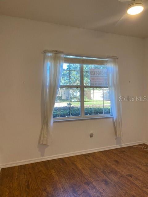 GUEST BEDROOM WITH LOVELY HARDWOOD FLOORS.