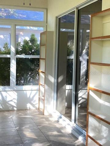 LANAI WITH TWO SETS OF PATIO DOORS FOR ENTRANCE.