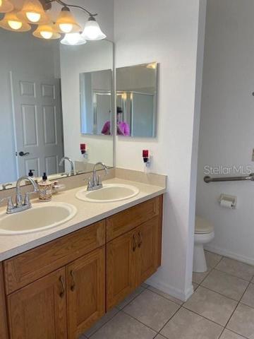 DOUBLE SINK VANITY IN MASTER BATHROOM WITH PRIVATE COMODE.