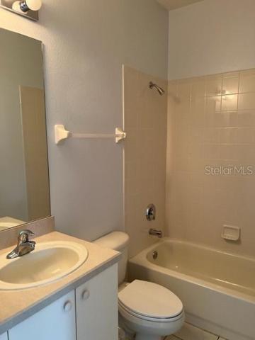 GUEST BATH WITH TILE FLOOR.
