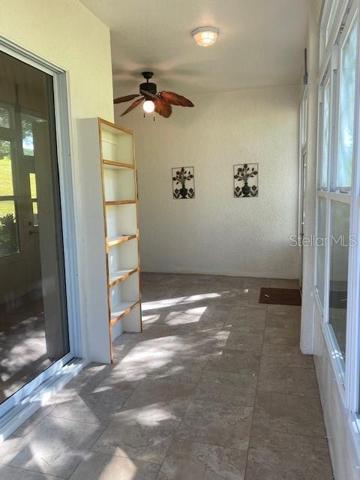 TILED LANAI WITH STORM WINDOWS.