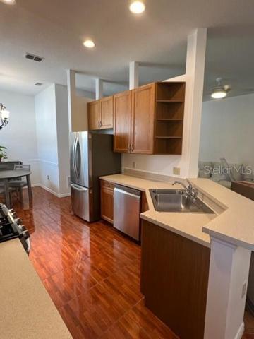 GORGEOUS WOOD TILE FLOORS IN KITCHEN WITH WOOD CABINETS.