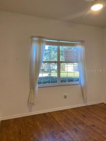 GUEST BEDROOM WITH LOVELY HARDWOOD FLOORS.