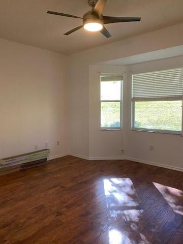 MASTER BEDROOM WITH STUNNING HARDWOOD FLOORS.