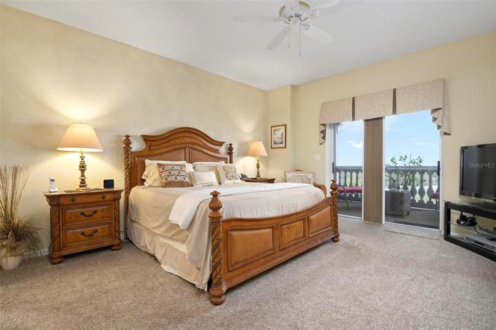 Master bedroom with sliders to screened balcony