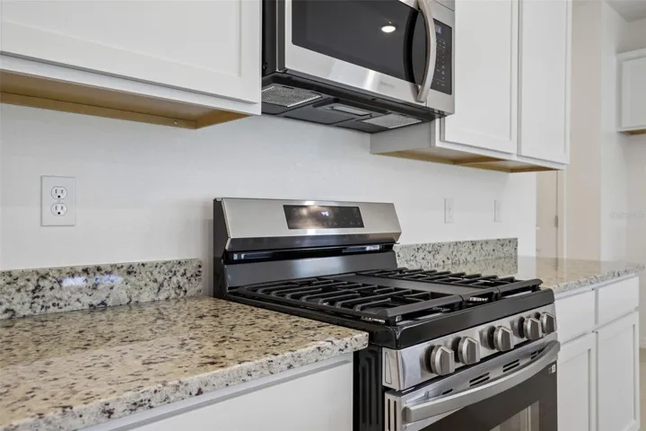 Granite Countertops, Stainless Appliances & Spacious Island Built-in Shelving