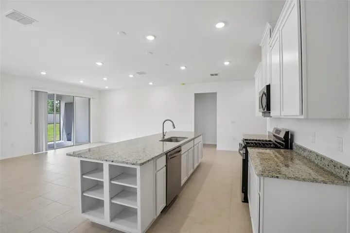 Granite Countertops, Stainless Appliances & Spacious Island Built-in Shelving