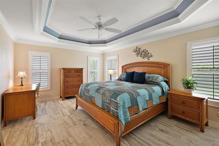 Master bedroom w/tray ceiling & plantation shutters