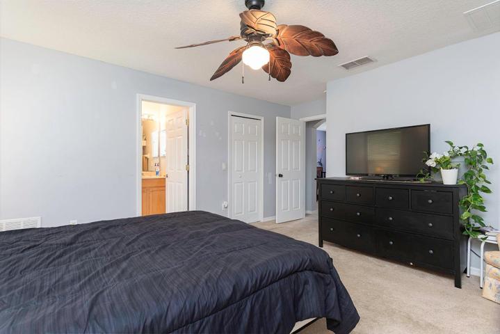 Master bedroom with large walk-in closet and ensuite bathroom.