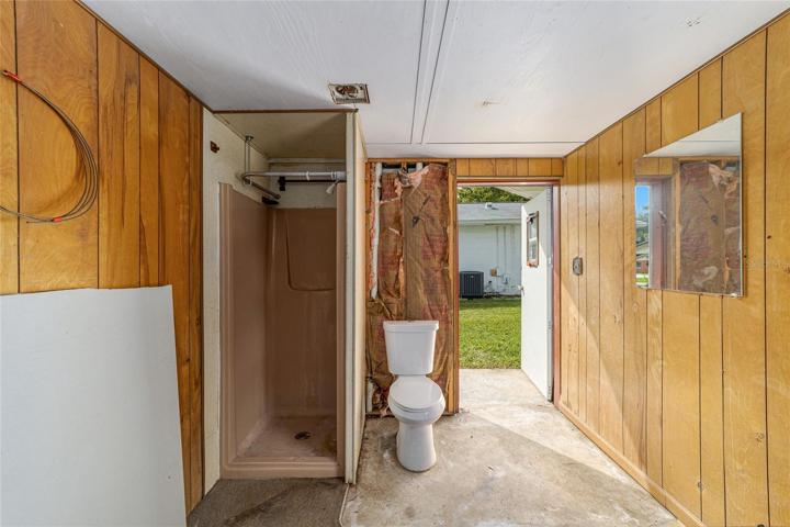 inside pool house with shower and toilet