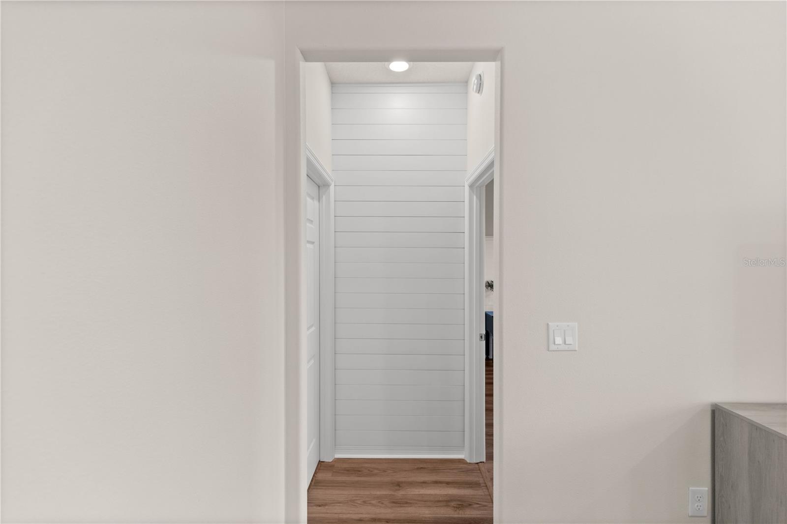 Custom shiplap hall wall heading into primary bedroom.