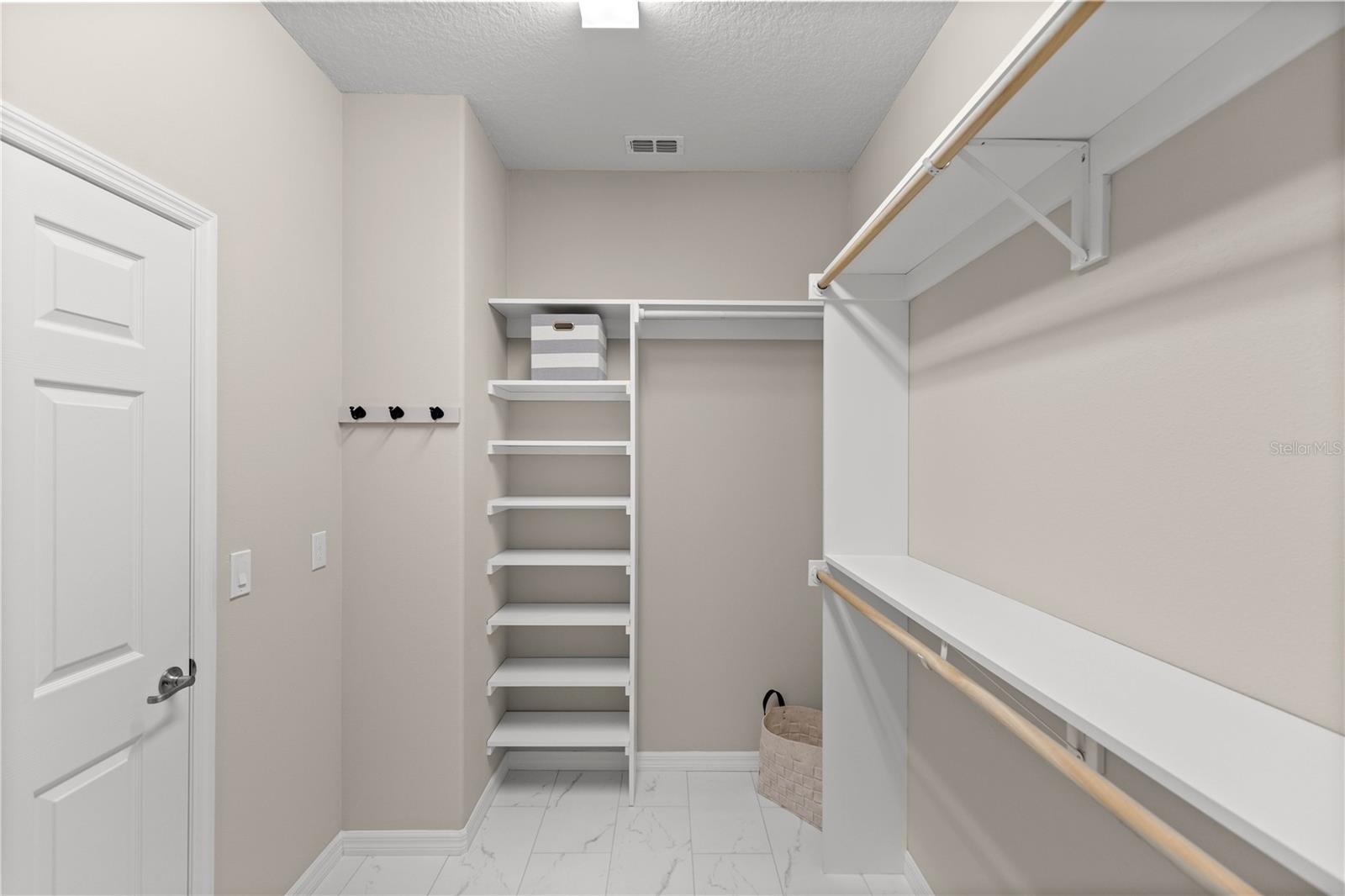 Lots of storage with shelving in owner's closet. New tiled floors matching primary bathroom floors. No icky carpet in this house now.