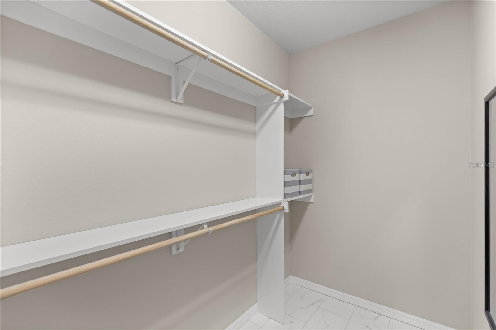 Owner's walk-in closet with lots of storage.