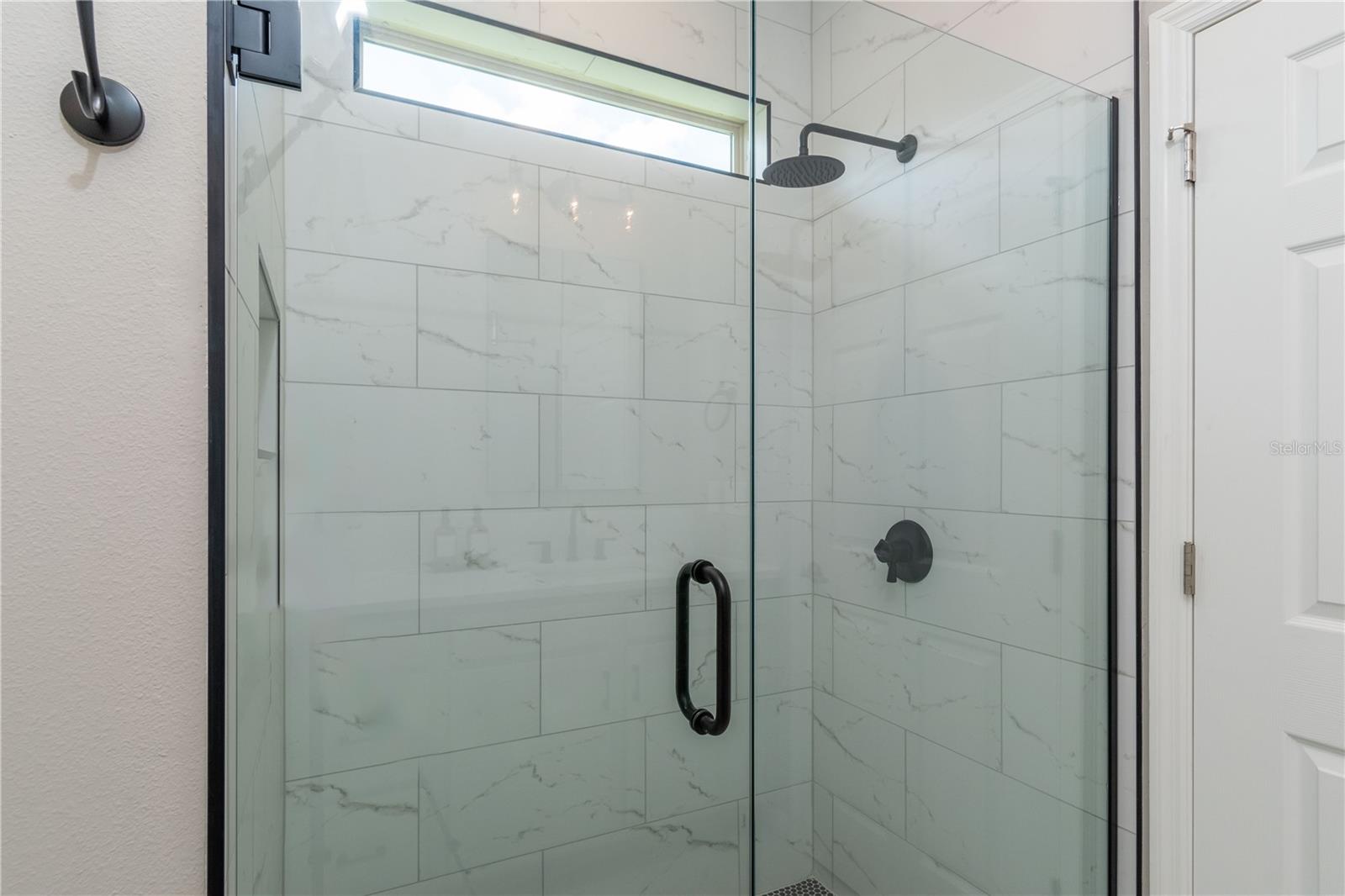 Owner's bath all new large, custom walk-in shower with high-end finishes and frameless glass shower door.  Extra large shower niche on left shower wall. Gorgeous!
