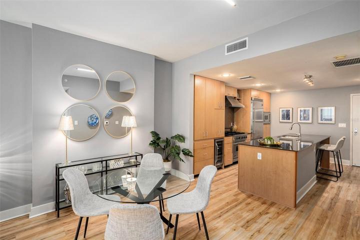 Spacious living area features eating space at the island and room for a separate dining table