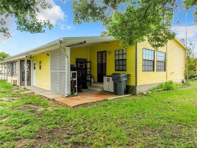 Backyard and view of the home. The door on the left will take you into the Florida room