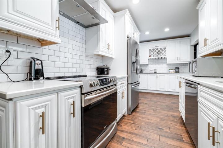 the far end of this kitchen has a unique area for a wine or coffee bar set up