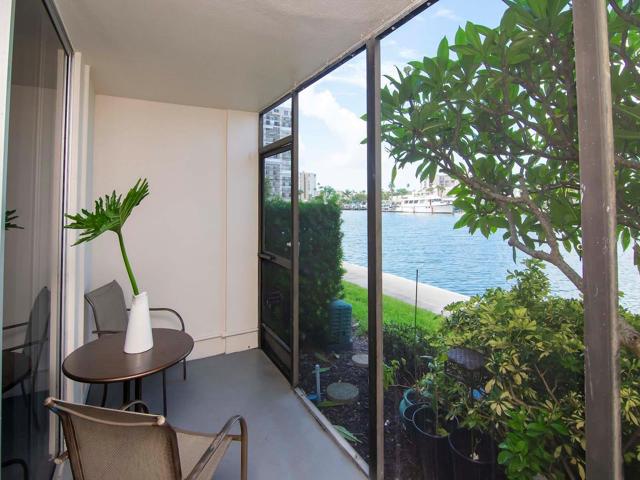 Private exterior screened in lanai for great waterfront view with door access directly to the sidewalk great for pet owners with furry friends, enjoying a nice walk in the morning or just having a coffee at sunrise