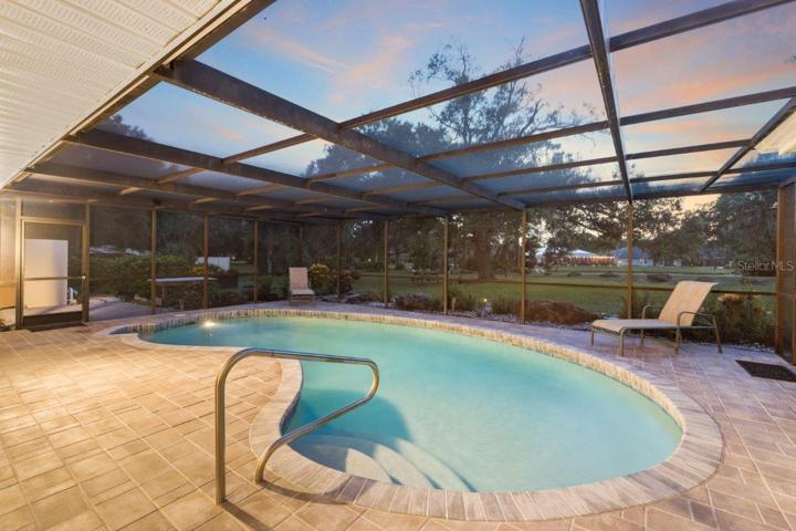 Huge Renovated Screened-in lanai with a freshly resurfaced pebble tec pool, and gorgeous views of the back yard and lake.