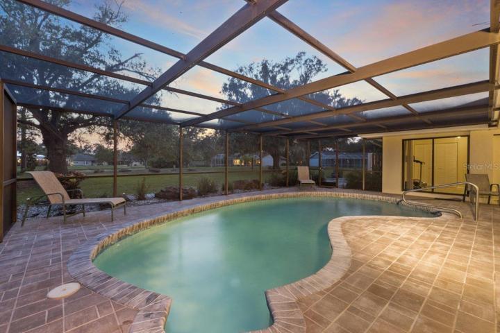 Huge Renovated Screened-in lanai with a freshly resurfaced pebble tec pool, and gorgeous views of the back yard and lake.