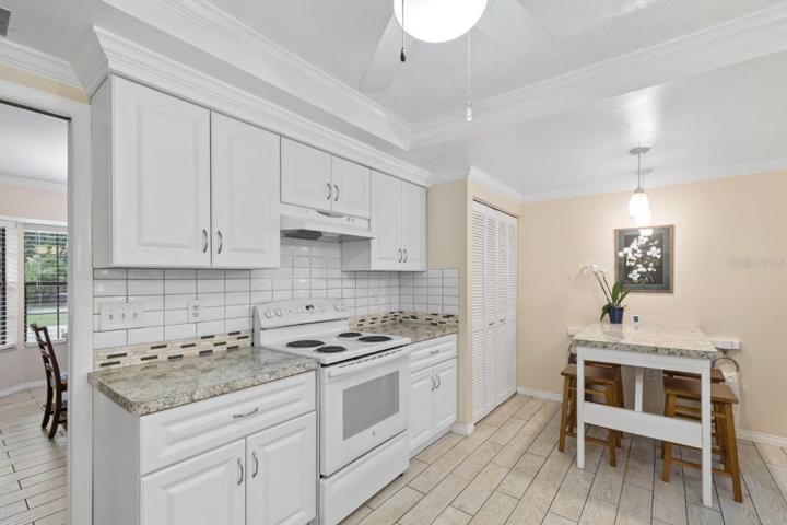 Recently remodeled gourmet kitchen with a spacious breakfast bar with a pass through window, custom eat-in kitchen space, and tray ceilings.