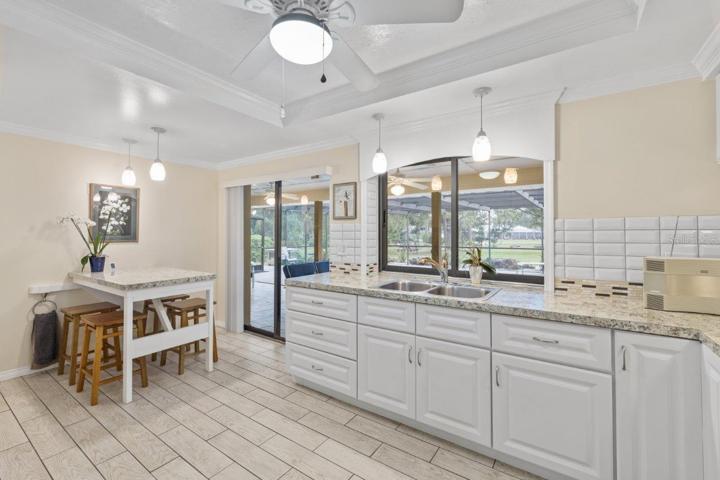 Recently remodeled gourmet kitchen with a spacious breakfast bar with a pass through window, custom eat-in kitchen space, and tray ceilings.