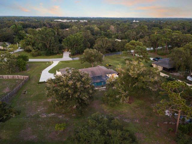 Aerial of the rear elevation of the home showing the size of the 1 acre property