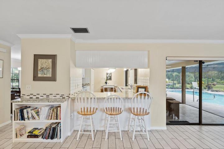 Breakfast bar in the living room with a pass through window to the kitchen.