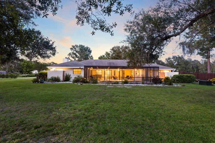 Rear elevation of the home showing the large newly renovated screened-in lanai and pool.