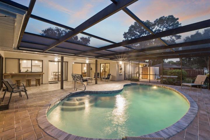 Huge Renovated Screened-in lanai with a freshly resurfaced pebble tec pool, and gorgeous views of the back yard and lake.