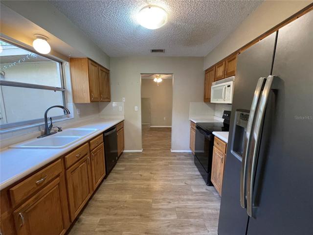 WINDOW OVER THE SINK AND PLENT OF CABINETS FOR STORAGE