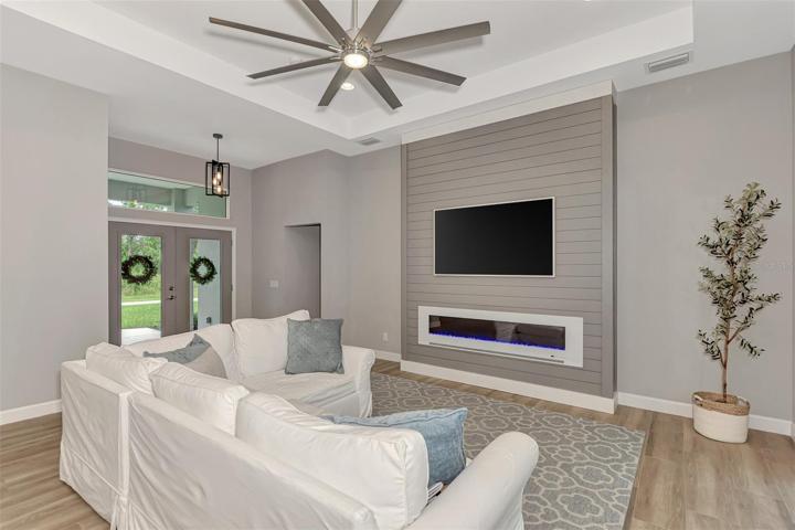 View of the electric fireplace, Ship lap design and interior living.