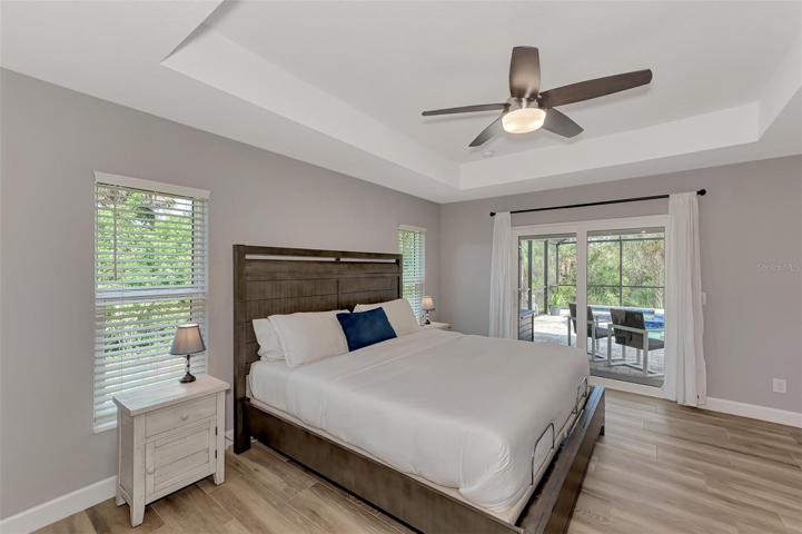 Master bedroom with sliding doors leading out to the Pool.