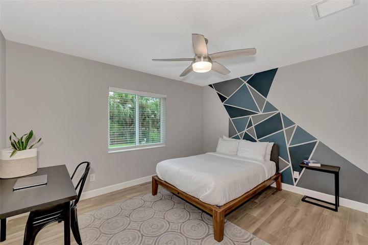 Guest bedroom 2 is oversized with remote ceiling fan and good size closet.