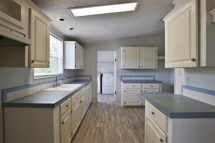Kitchen with laundry In distance.