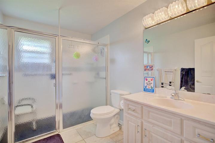 Shared bathroom with expanded shower area and mobility features