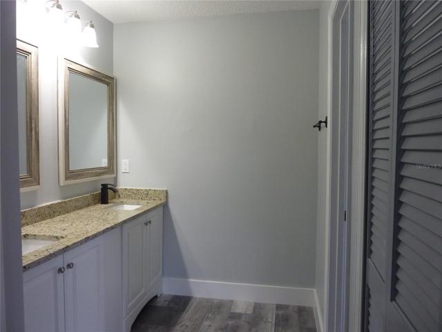 Master bathroom with dual sinks, walk in closet and shower/water closet